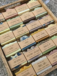 several bars of soap sitting on top of each other in a wooden box next to some rocks