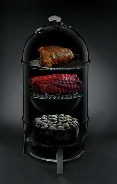 an image of meat on the grill with other food items in it's display case