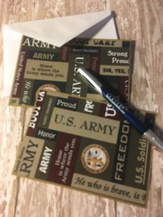 two us army coupons and a pen on a wooden table