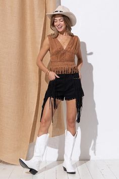 Unleash your inner cowgirl with the Emie Fringe Suede Top! Made with luxurious suede, this studded crop tank features a deep V neckline and a playful fringe bottom. Perfect for rodeo season or any time you want to add a touch of western flair to your wardrobe! Fit: This top is intended to be fitted in the bust and waist with a relaxed fringe hem along the hips featuring a deep v-neckline and open back. Bust: The bust is intended to be fitted. Waist: The waist is intended to be fitted. Hips: The Suede Top, Suede Tops, Crop Tank, Deep V, Rodeo, Loose Fitting, Wardrobe, How To Wear