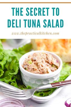 the secret to deli tuna salad in a white bowl with lettuce and red onions