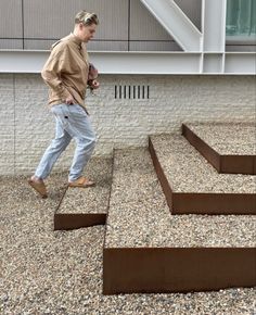 a man walking up some steps in front of a building with no shoes on it