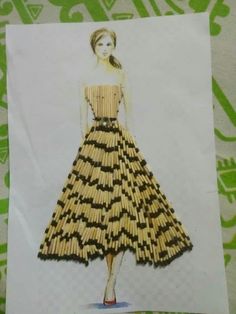 a woman's dress made out of matchesticks on a piece of paper