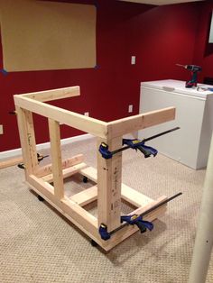 an unfinished workbench in the middle of a room with tools attached to it