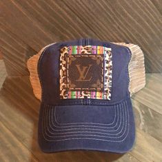 New denim worn look trucker hat with genuine Serape and Leopard Print leather patch and with authentic upcycled L V canvas sewn on it. We are not associated with any brand name. We only use 100% authentic items in our products that we upcycle into something handmade. Please message us for more information.. Thank you and Happy Shopping :) Kept this one for myself! It really fires up my western style! DISCLAIMER: WAITES MADE DOES NOT SELL LICENSED LOUIS VUITTON OR GUCCI PRODUCTS. ALL OF OUR CANVA Casual Baseball Cap With Leather Patch, Casual Trucker Hat With Leather Patch, Casual Brown Hat With Patches, Leopard Hat, Louis Vuitton Hat, Handbag Boutique, Western Handbags, Denim Wear, Boutique Accessories