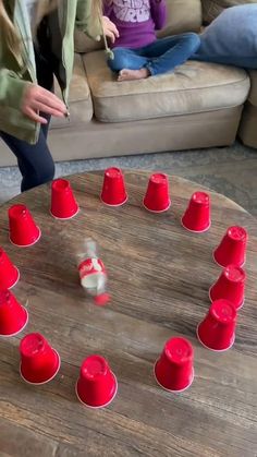 a group of red cups sitting on top of a wooden table