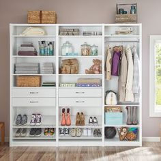 a white closet filled with lots of clothes and shoes