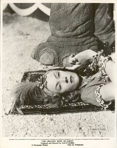 an old photo of a woman laying on the ground