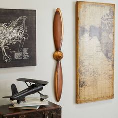 an airplane propeller mounted on the wall next to a map