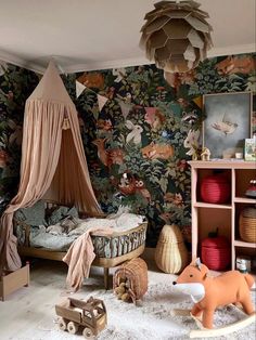 a child's bedroom with floral wallpaper and wooden toys in the foreground