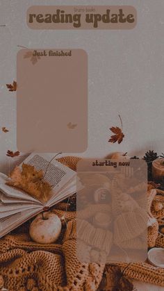 a pile of books sitting on top of a table next to autumn leaves and pumpkins