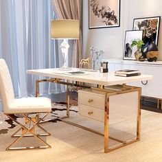 a white desk with gold legs in front of a floral wallpaper