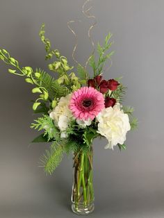 a vase filled with white and pink flowers