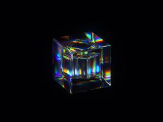 an image of a cube in the dark with colored lights on it's sides