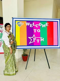 a woman standing in front of a welcome sign