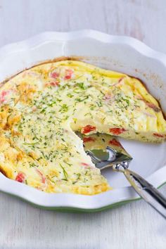 a quiche with cheese and vegetables in a white dish