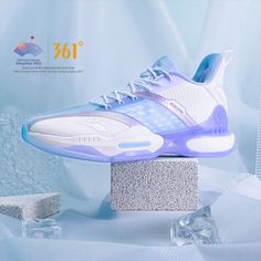 a pair of shoes on top of a block of ice in front of a blue background