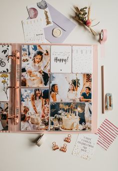 an open photo album with photos and other items on it, including pens, scissors, paper clips, and magnets