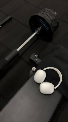 a pair of headphones sitting on top of a black table next to a gym bag