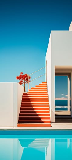 an outdoor swimming pool with steps leading up to the water's edge and a tree in the distance