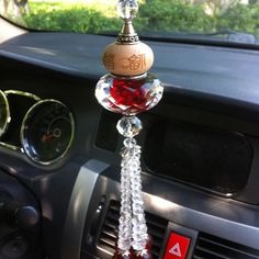 a car dashboard with a wine bottle hanging from the dash board