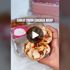 a person holding a chicken wrap in their hand with the text healthy, high protein garlic parm chicken wrap