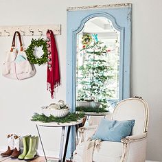 a room with a chair, mirror and christmas decorations