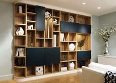 a living room filled with lots of wooden shelves