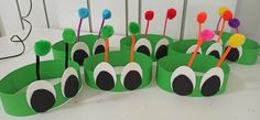 paper cups with toothpicks in the shape of green monster's mouths and eyes