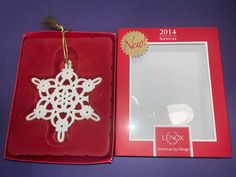 an ornament in a red box with a white snowflake on it