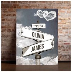 a street sign in front of a brick wall with the words oliva and james on it