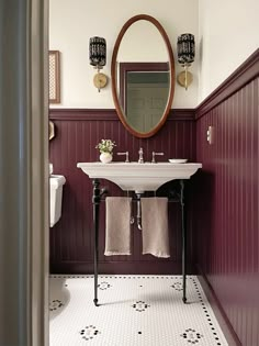 a white sink sitting under a mirror in a bathroom