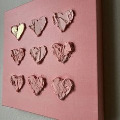 a pink canvas with hearts cut out of it