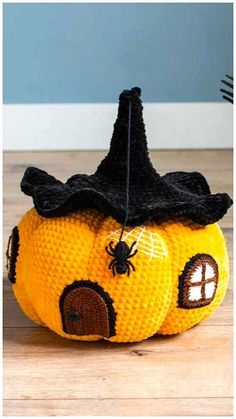 a knitted pumpkin with a witches hat on top