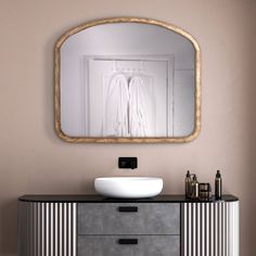 a bathroom vanity with a mirror above it and a bowl on the counter top in front of it