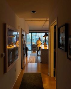 a man is standing in the kitchen looking at something on the counter while he's preparing food