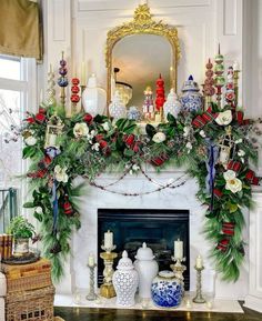 a mantel decorated with greenery and christmas decorations