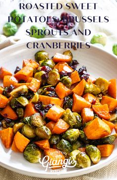 roasted sweet potatoes, brussel sprouts and cranberries on a white plate