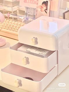 an office desk with three drawers and a keyboard