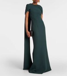 This Safiyaa gown features a cape, a round neck, a fitted bodice, a long skirt, and a back zip closure. The gown is made of 92% polyester and 8% elastane. It is dry clean only and made in Turkey. Cape Gown, Fitted Bodice, Green Orange, Orange Red, Long Skirt, Dry Clean Only, Cape, Bodice, Round Neck