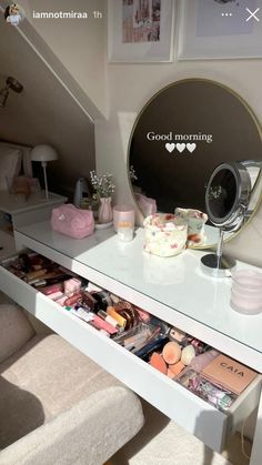 a vanity table with drawers and makeup products on it in front of a mirror that says good morning