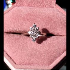 an engagement ring in a pink velvet box