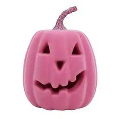 a pink halloween pumpkin with a cat's face carved into it