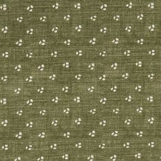 an olive green background with white dots and small circles on the fabric, which is very soft