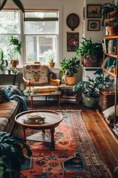 a living room filled with furniture and lots of plants