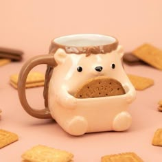 a mug with a bear in it is surrounded by crackers