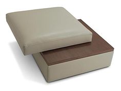 a white and brown ottoman sitting on top of each other