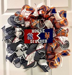 a baseball wreath is hanging on a door with the word house divided written in it