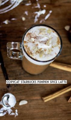 an overhead view of a hot chocolate drink with whipped cream and cinnamon on the rim