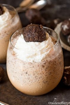 two desserts in small glasses on a table